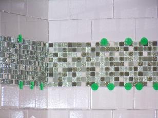 The ungrouted backsplash goes up.